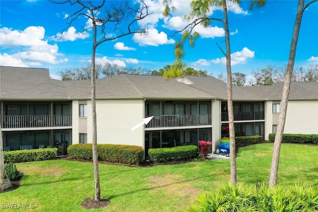 rear view of house with a lawn