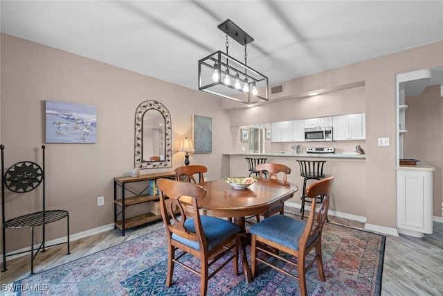 dining area with light hardwood / wood-style floors