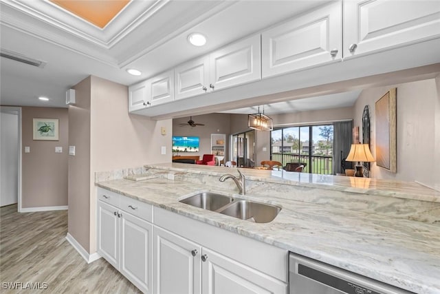 kitchen featuring sink, stainless steel dishwasher, white cabinets, and light hardwood / wood-style flooring