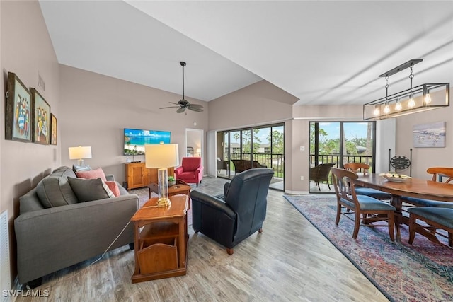 living room with vaulted ceiling, light hardwood / wood-style floors, and ceiling fan