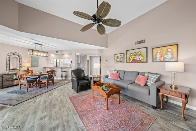 living room with ceiling fan and wood-type flooring