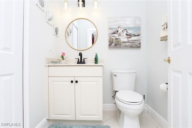 bathroom featuring vanity, tile patterned floors, and toilet