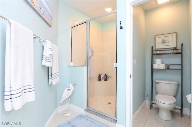 bathroom featuring tile patterned floors, toilet, and a shower with shower door