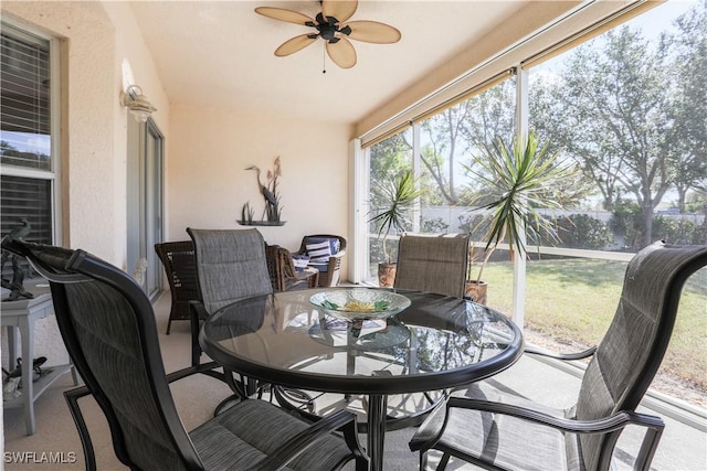 sunroom / solarium featuring ceiling fan