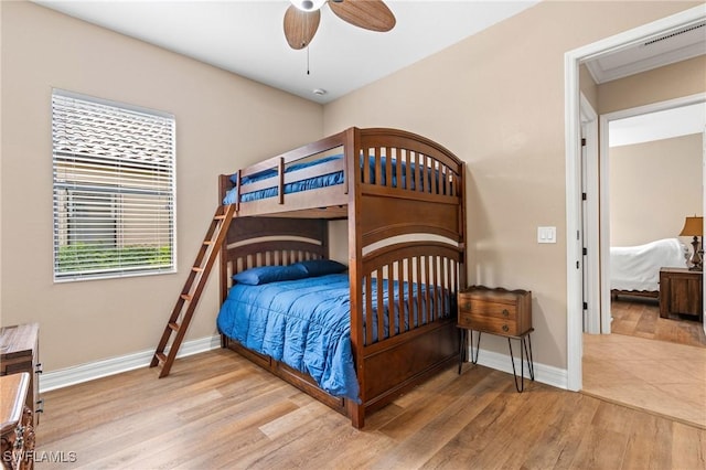 bedroom with a ceiling fan, baseboards, and wood finished floors