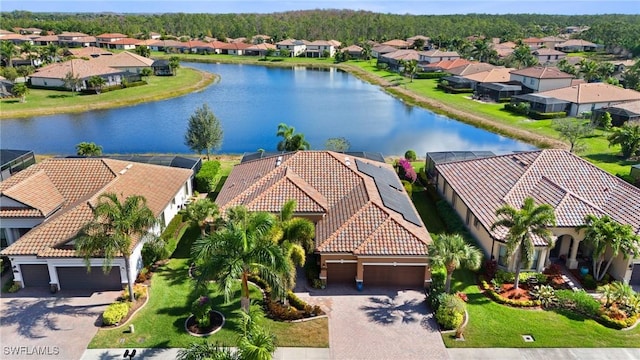 birds eye view of property featuring a water view and a residential view