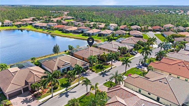 drone / aerial view featuring a residential view and a water view