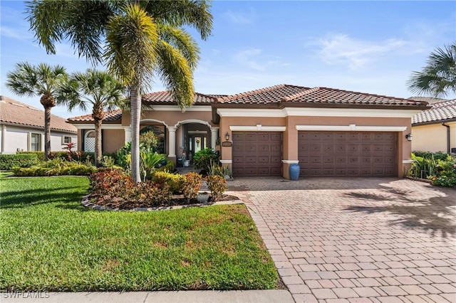 11035 Longwing Dr, Fort Myers, FL 33912 - mediterranean / spanish-style home featuring decorative driveway, a front yard, a garage, and stucco siding
