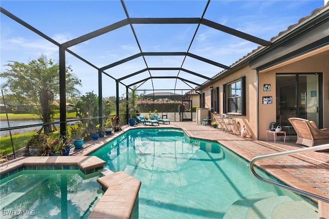 view of pool with a patio area and a pool with connected hot tub