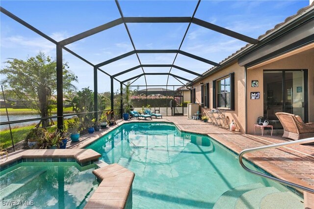 11035 Longwing Dr, Fort Myers, FL 33912 - view of pool with a pool with connected hot tub, a patio area, and glass enclosure