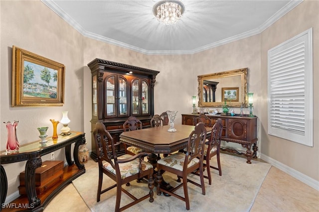 dining room with ornamental molding, a notable chandelier, baseboards, and light tile patterned floors