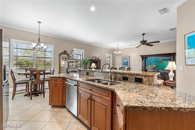 kitchen featuring dishwasher, visible vents, brown cabinetry, and a sink