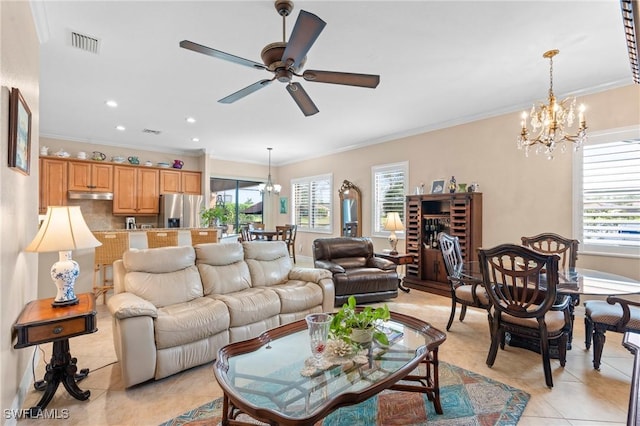 living room with a healthy amount of sunlight, crown molding, visible vents, and light tile patterned floors