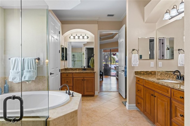 bathroom featuring a garden tub, ornamental molding, a sink, and tile patterned floors