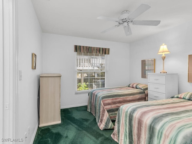 bedroom featuring ceiling fan and dark carpet