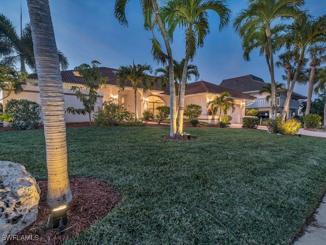 mediterranean / spanish-style home featuring a front yard