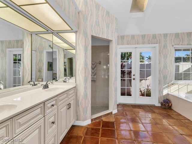 bathroom featuring vanity, a tile shower, tile patterned floors, and french doors