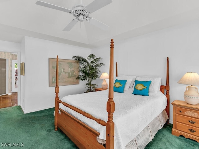 bedroom featuring ceiling fan and dark carpet