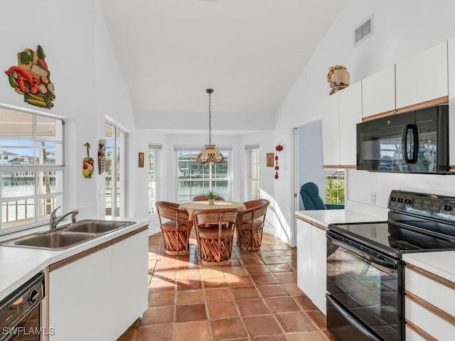 kitchen featuring sink, hanging light fixtures, high vaulted ceiling, black appliances, and white cabinets