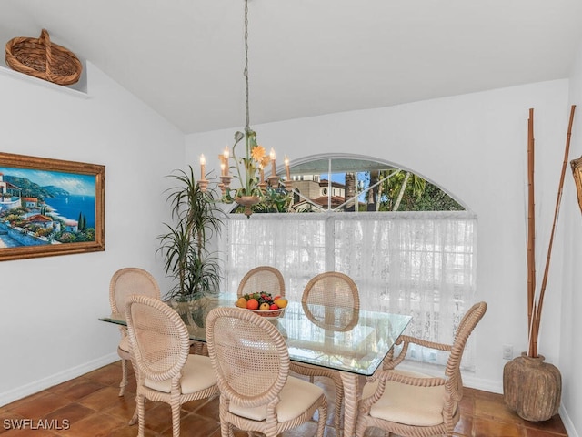 dining space featuring lofted ceiling, tile patterned flooring, and a chandelier