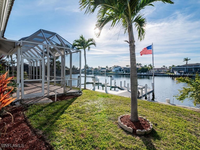 dock area with a water view and a yard