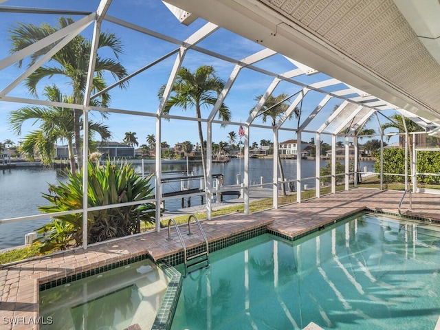 view of swimming pool featuring a water view, a patio area, glass enclosure, and a jacuzzi