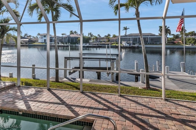 view of dock featuring a lanai and a water view