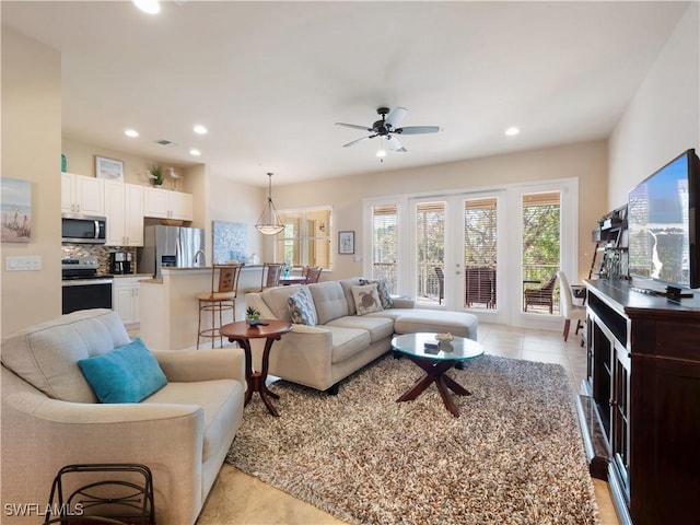 living room featuring light tile patterned flooring, ceiling fan, and french doors