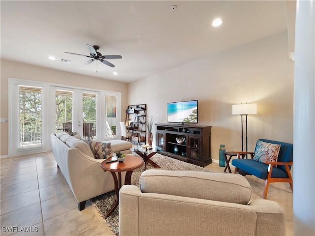 tiled living room with ceiling fan and french doors