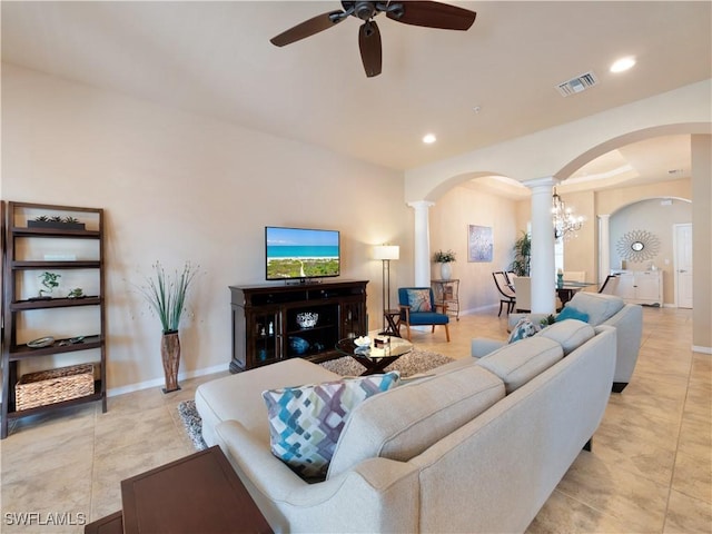 living room with ceiling fan and ornate columns