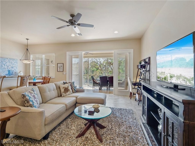 living room with ceiling fan and light tile patterned flooring