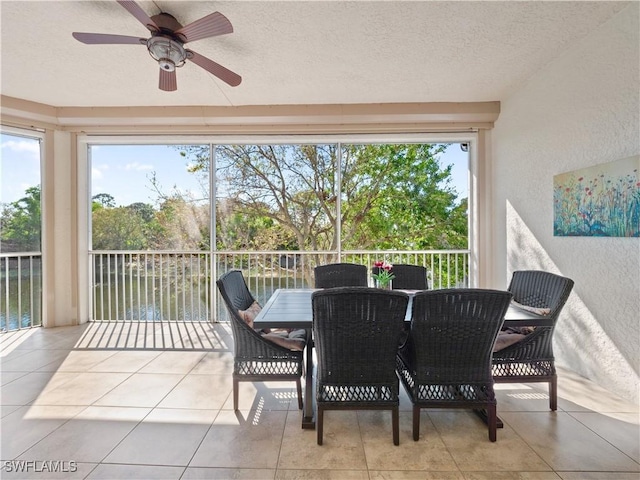 sunroom featuring ceiling fan