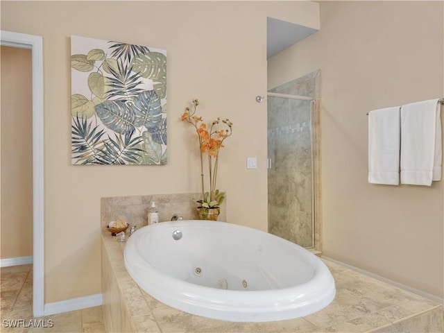 bathroom featuring tile patterned floors and separate shower and tub