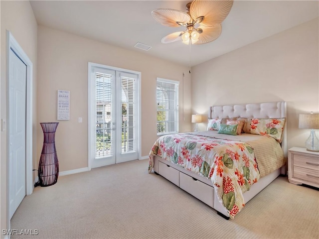 bedroom featuring light carpet, access to exterior, and ceiling fan