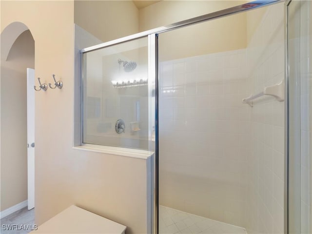 bathroom with a shower with shower door