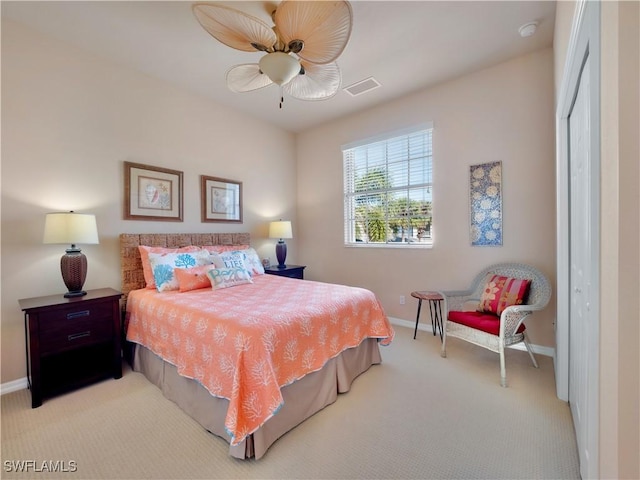 bedroom featuring light carpet and ceiling fan