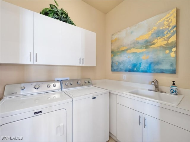 laundry area with cabinets, sink, and washing machine and clothes dryer