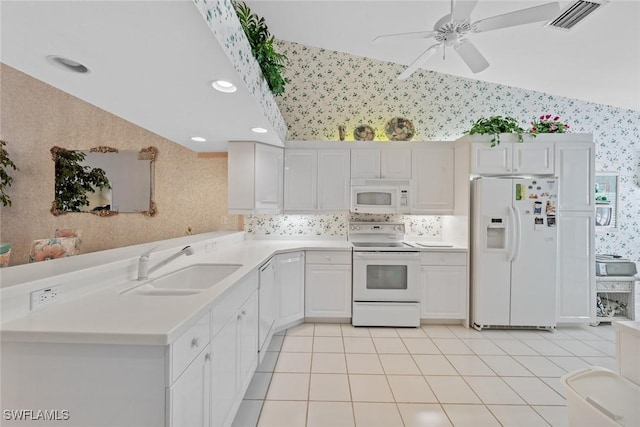 kitchen with white appliances, wallpapered walls, visible vents, light countertops, and white cabinetry