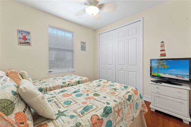 bedroom with ceiling fan, dark hardwood / wood-style flooring, and a closet