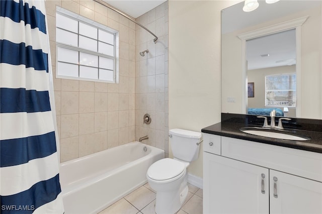 ensuite bathroom with ensuite bathroom, toilet, vanity, tile patterned floors, and shower / bath combo