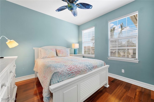 bedroom featuring dark wood-style floors, baseboards, and a ceiling fan