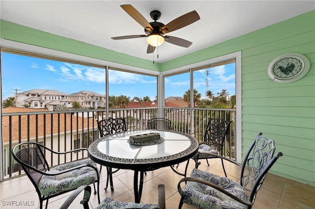 sunroom featuring ceiling fan