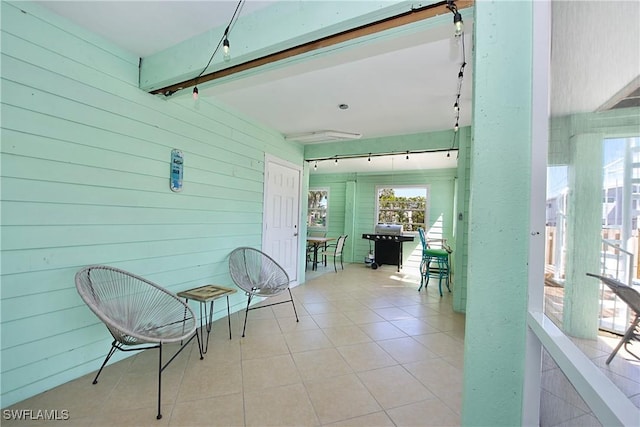 sunroom featuring beam ceiling