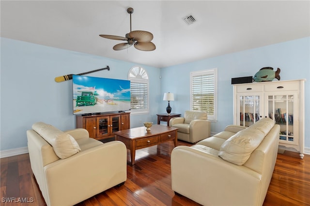 living room featuring baseboards, dark wood finished floors, visible vents, and a ceiling fan