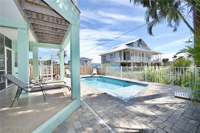 view of swimming pool featuring a patio area, stairs, fence, and a fenced in pool