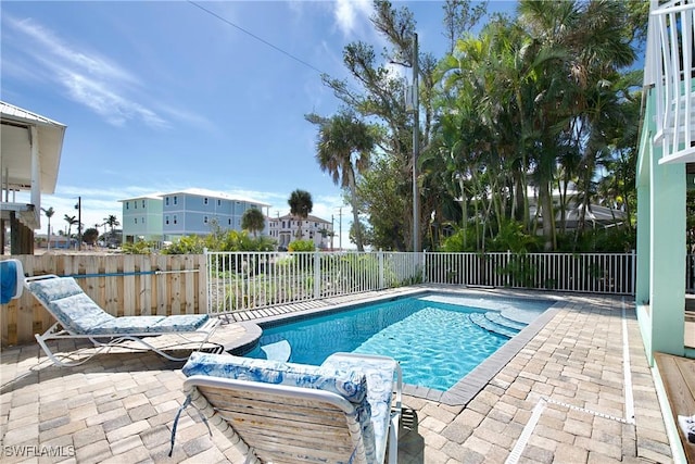 view of swimming pool featuring a fenced backyard, a fenced in pool, and a patio