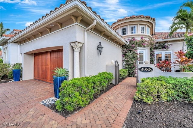 mediterranean / spanish house featuring a garage