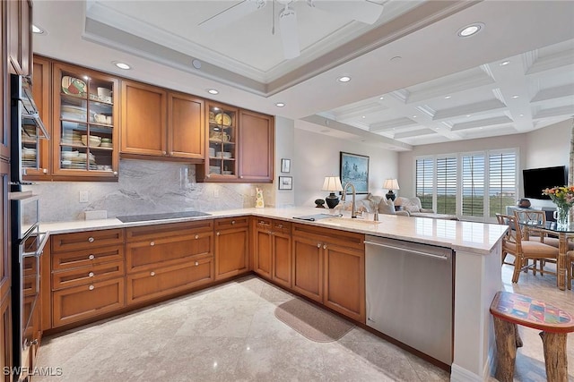 kitchen featuring open floor plan, black electric stovetop, dishwasher, a peninsula, and brown cabinets