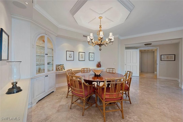dining space with baseboards, crown molding, and a chandelier