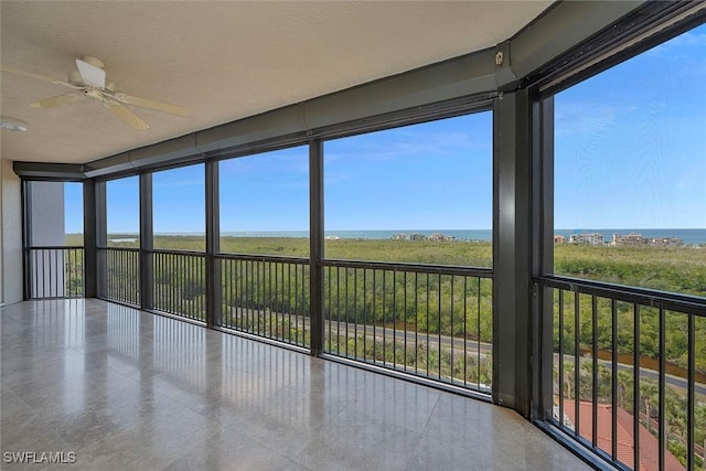 unfurnished sunroom with floor to ceiling windows and a textured ceiling